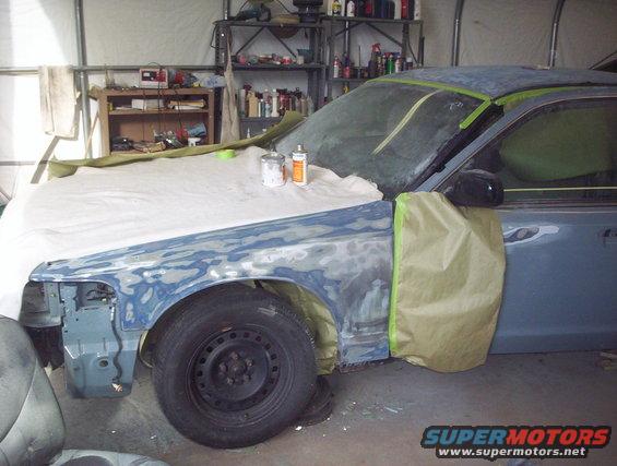 1998 Ford Crown Victoria undergoing bodywork, front fender and hood covered