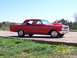 1994 Ford Bronco - This red coupe features a prominent hood scoop and drag-style wheels, captured on a sunny day.