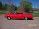 1994 Ford Bronco - Side view of a red 1963 Ford Falcon with a hood scoop and aftermarket wheels.