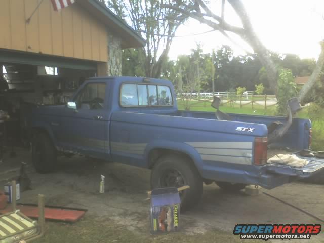 Blue pickup truck with STX badging, parked in a garage