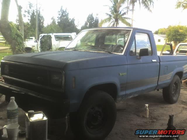 Blue pickup truck with a black grille and bumper, parked outdoors