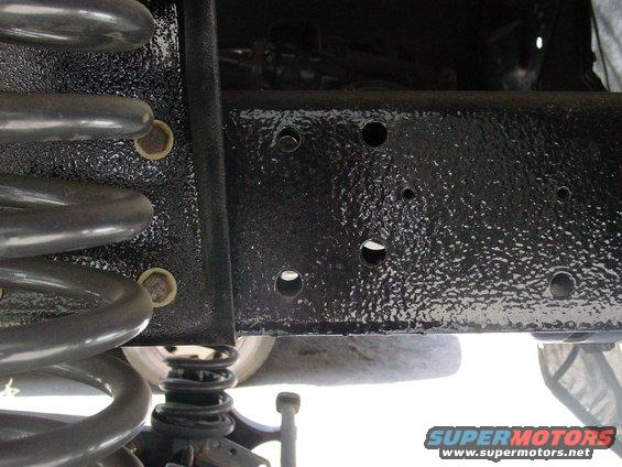 Close-up of vehicle frame and coil spring