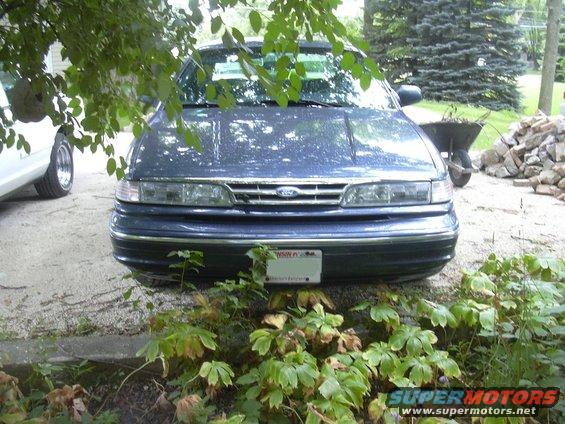 1997 Ford Crown Victoria front view, parked outside with foliage in foreground