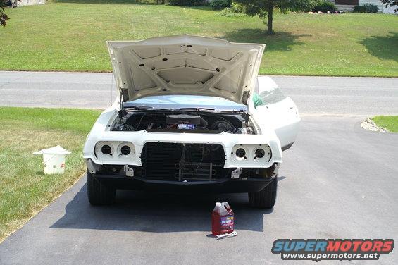 White 1972 Ford Ranchero with hood open, front view, undergoing restoration
