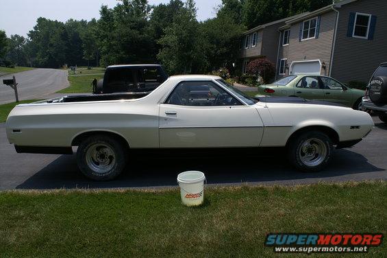 White 1972 Ford Ranchero pickup truck, side view, with black hood accent and aftermarket wheels