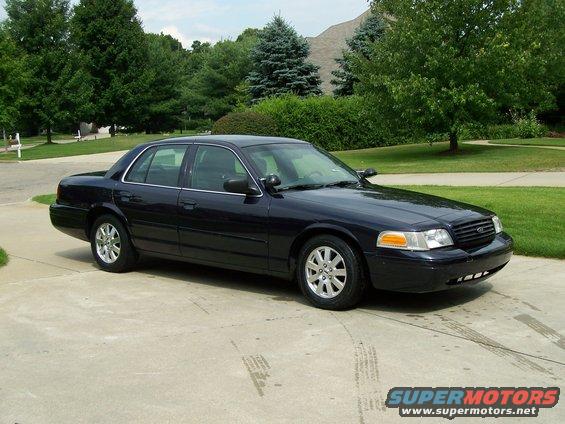 Dark blue 2003 Ford Crown Victoria parked on a concrete driveway