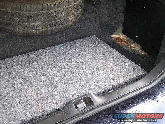 Spare tire and carpeted floor in a car trunk