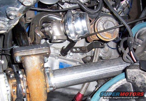 Close-up of a turbocharger and exhaust manifold with associated plumbing and wiring