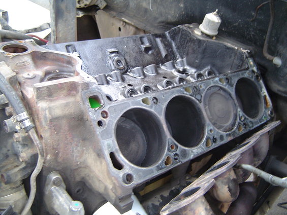 Engine block with gasket removed, showing cylinder bores