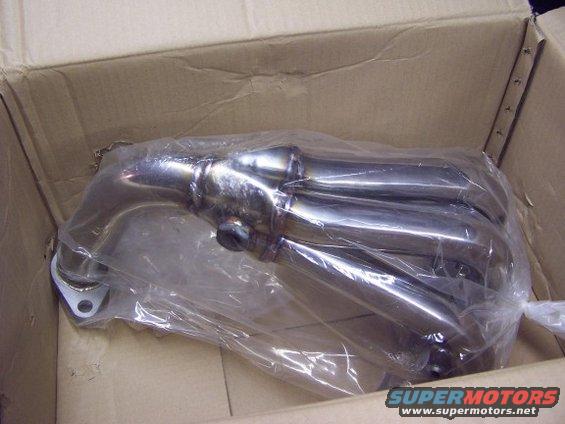 Exhaust manifold in plastic wrap inside a cardboard box