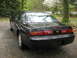1995 Nissan 240SX - Rear view of a black 1995 Nissan 240SX coupe parked outdoors.