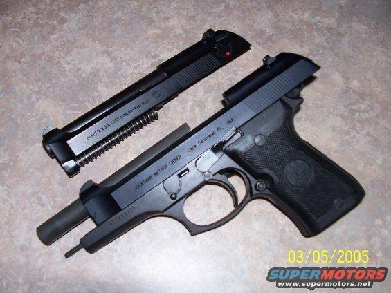 Beretta pistol disassembled, showing slide and frame