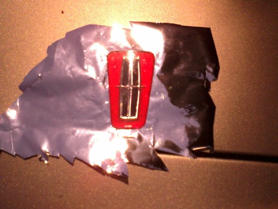 chromefilm.jpg I sprayed the star's background black, and the surround candy red for a unique look.
I used candy apple red to duplicate factory color. Standard black in the center.

To achieve the pearlescent look of the stock emblem, I used some mylar film on the back. This worked excellent for this.