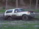 1990 Ford Bronco - This Ford Bronco is deep in the mud, with its tires partially submerged.