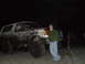 1990 Ford Bronco - A muddy 1990 Ford Bronco is shown in this nighttime photo with a person standing beside it.