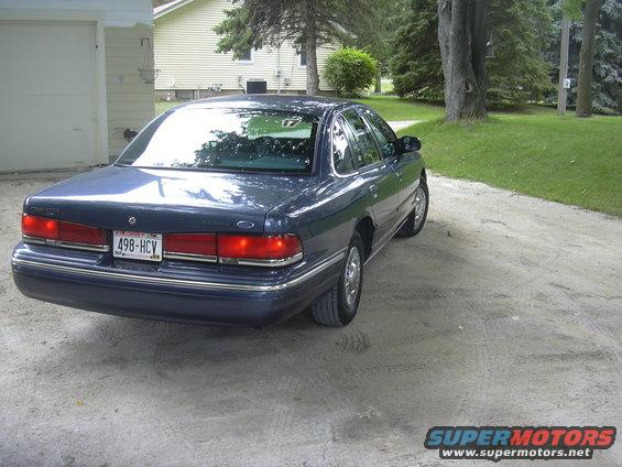 Dark blue 1996 Ford Crown Victoria parked on a dirt driveway