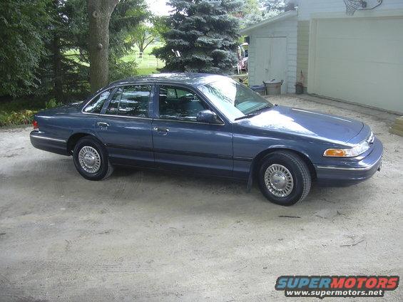 1996 Ford Crown Victoria parked outside a garage