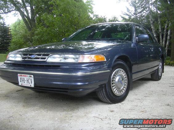 Dark blue sedan with chrome hubcaps and a Wisconsin license plate