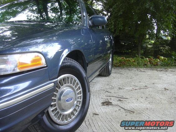 Blue 1996 Ford Crown Victoria, front passenger side, parked on dirt road