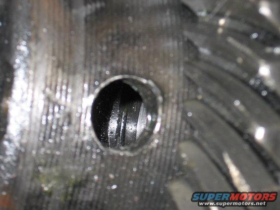 Close-up of gears with a hole, likely a differential component