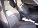 1993 Ford Probe - The interior of a car shows fabric seats, a center console, and a parking brake lever.