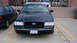1998 Ford Crown Victoria - Front view of a black 1998 Ford Crown Victoria parked in a lot.