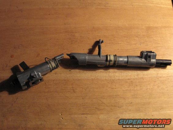 Broken fuel injector on wooden surface