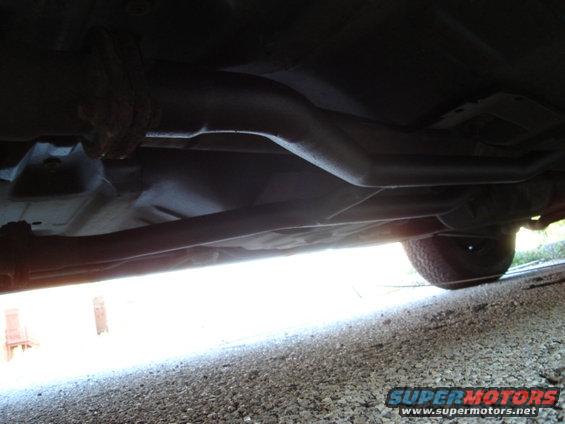 Undercarriage view of exhaust system and tire