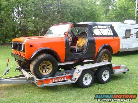 Orange International Harvester Scout II on U-Haul trailer, soft top removed, doors off