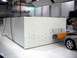 1971 Ford Ranchero - A silver car is positioned in front of a large white testing apparatus within a spacious facility.