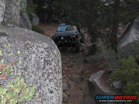 Black 1997 Chevrolet C/K Pickup navigating a rocky trail
