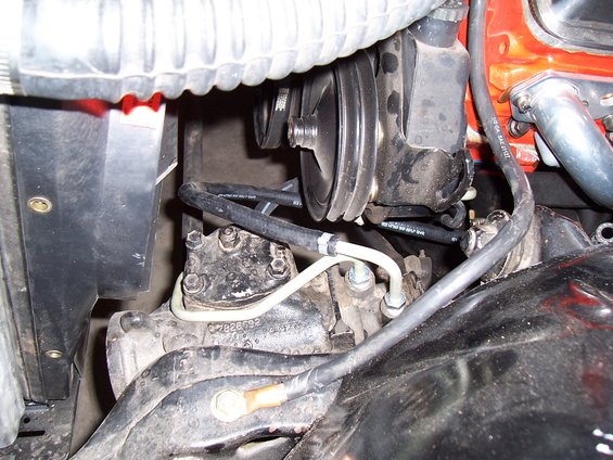 Engine compartment detail showing power steering pump and hoses