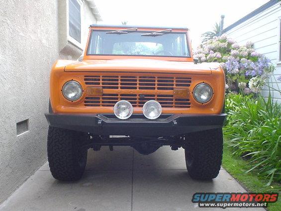 1977 Ford Bronco front view with orange paint and aftermarket bumper