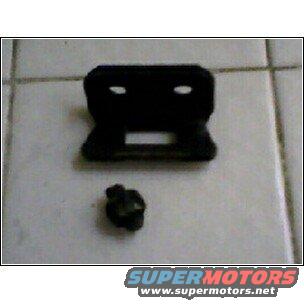 black plastic bracket and a small screw on a tiled surface