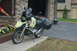 1998 BMW R1100GS ABS - A yellow BMW R1100GS motorcycle with black saddlebags is parked on a concrete pad in front of a stone-clad garage.