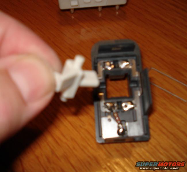 The white lever that actuates the contacts for the power window