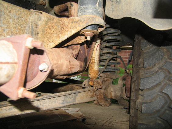 Exhaust pipe and suspension components of a vehicle