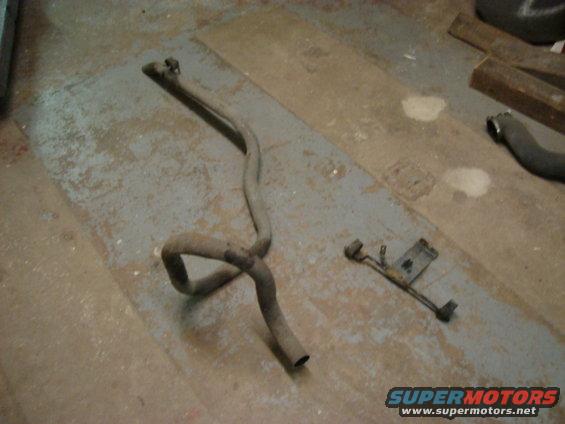Exhaust pipe and mounting bracket on a concrete floor