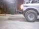 1990 Ford Ranger - Front wheel and fender of a 1990 Ford Ranger visible in a workshop setting.