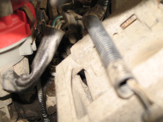 Engine bay wiring and components with red and gray plastic housing