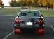 2005 Mazda 6 - The rear of a 2005 Mazda 6 sedan is shown, a spoiler and dual exhaust pipes.