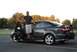 2005 Mazda 6 - A man poses with his dark gray sedan, which appears to be a 2005 Mazda 6, parked outdoors.