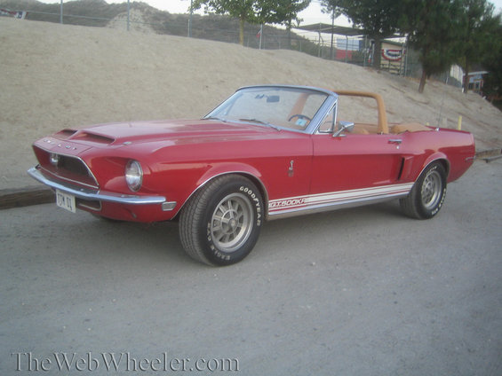 Red 1968 Shelby GT500KR convertible with tan interior and side stripes