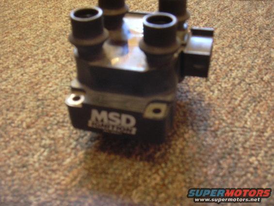 Black MSD ignition coil with four spark plug wire outputs, text reads "MSD IGNITION"