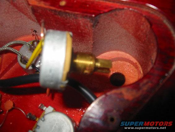 Potentiometer and wiring inside a red cavity