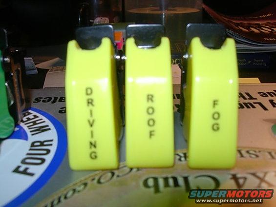 Three yellow auxiliary switches labeled DRIVING, ROOF, and FOG