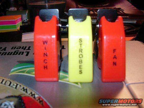 Three auxiliary switches, red ones labeled WINCH and FAN, yellow one labeled STROBES