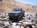 1989 Ford Bronco - This lifted Ford F-Series truck is navigating a challenging rocky obstacle course.