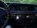 1994 Ford Crown Victoria - The interior of a car shows the dashboard with the steering wheel, radio, and climate controls.