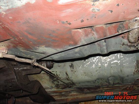 Underbody of a vehicle showing rust and a brake cable. Date stamp reads 2007 7 25
